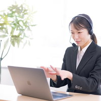 電話サポートで説明中のコールセンターオペレーター女性の写真