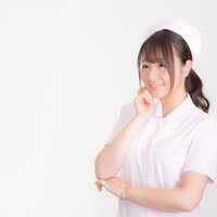 微笑む白衣の天使、ピンクのナースキャップをかぶった女性の写真