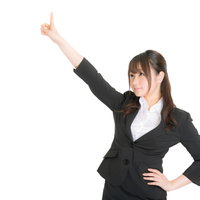 ナンバーワンと指をさすビジネススーツの女性の写真