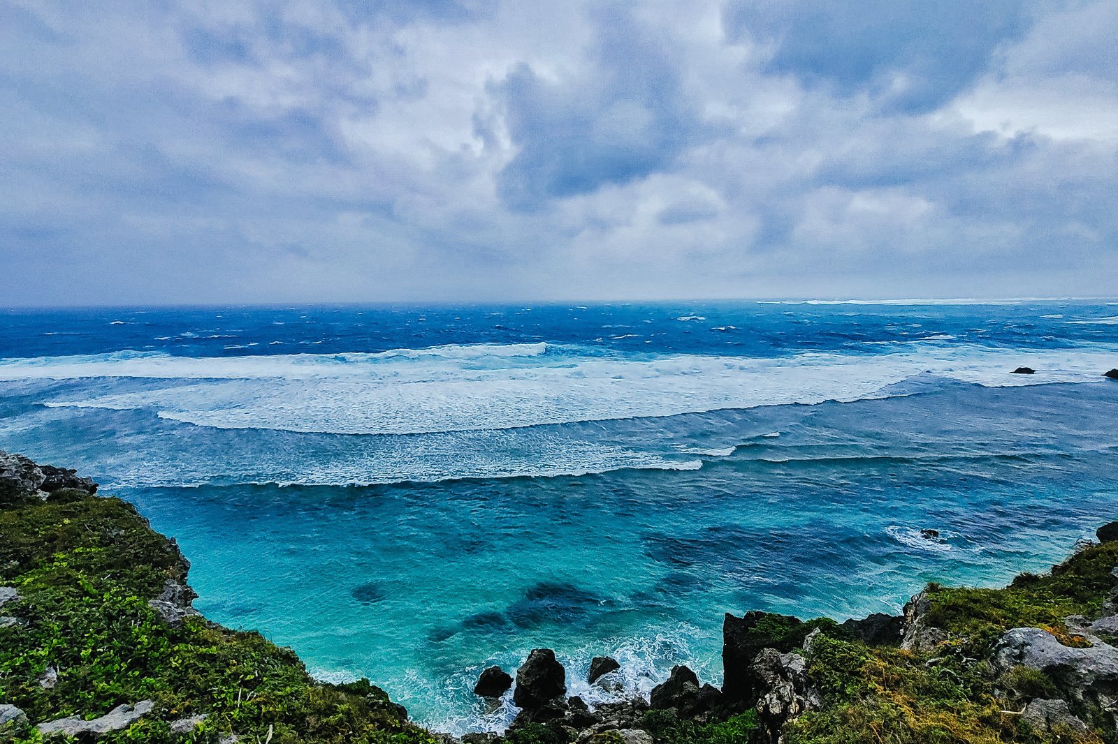 Emerald green sea and multiple waves viewed from the coast of Miyakojima Island