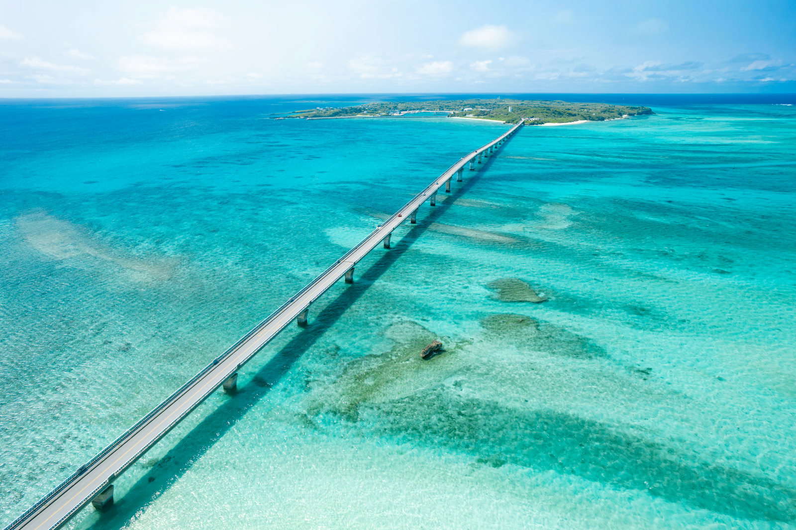 沖縄県宮古島の池間大橋と透明な池間ブルーの海を空から見た景観