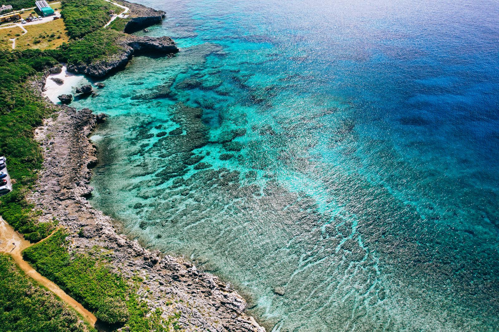 宮古島の岬から見下ろす透明度の高いエメラルドグリーンの海と岩場