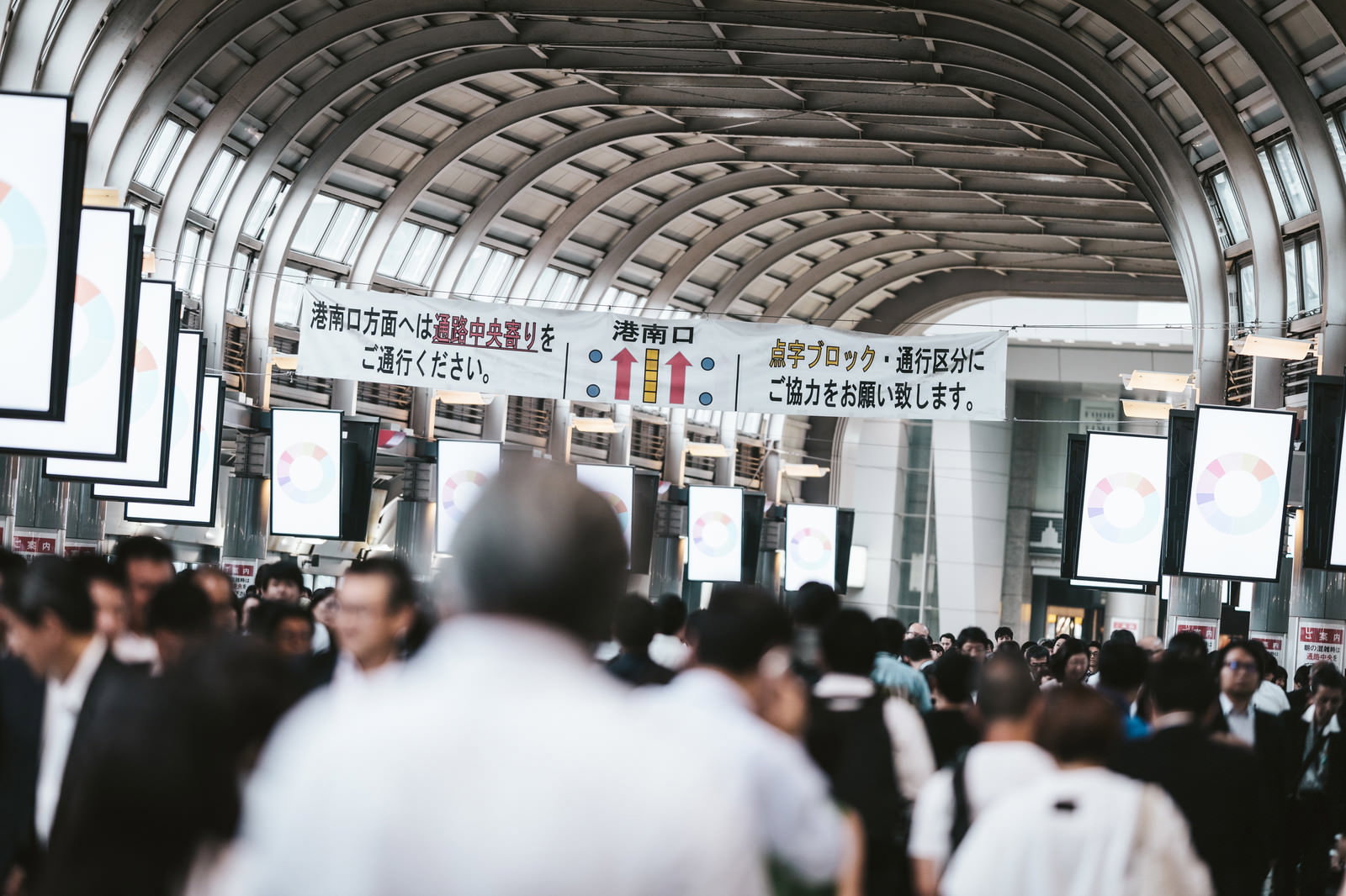 品川駅の自由通路で多くの人が行き交う混雑した駅構内の様子