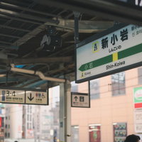 新小岩駅のホームに設置された駅名標と案内板の写真