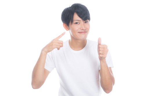 健康的な生活で肌の調子がいい男性が両手で親指を立てるポーズ