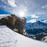 スイス・グリンデルワルトの雪山の尾根に貼られた吊橋（クリフウォーク）の写真