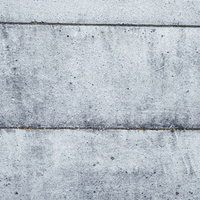 汚れや劣化が見られるコンクリートの壁のテクスチャーの写真