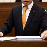 市議会の議場で質問に立つ議員の発言風景と議会活動の写真