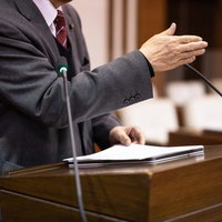 登壇して討論する津山市議会議員の熱弁による意見表明の様子の写真