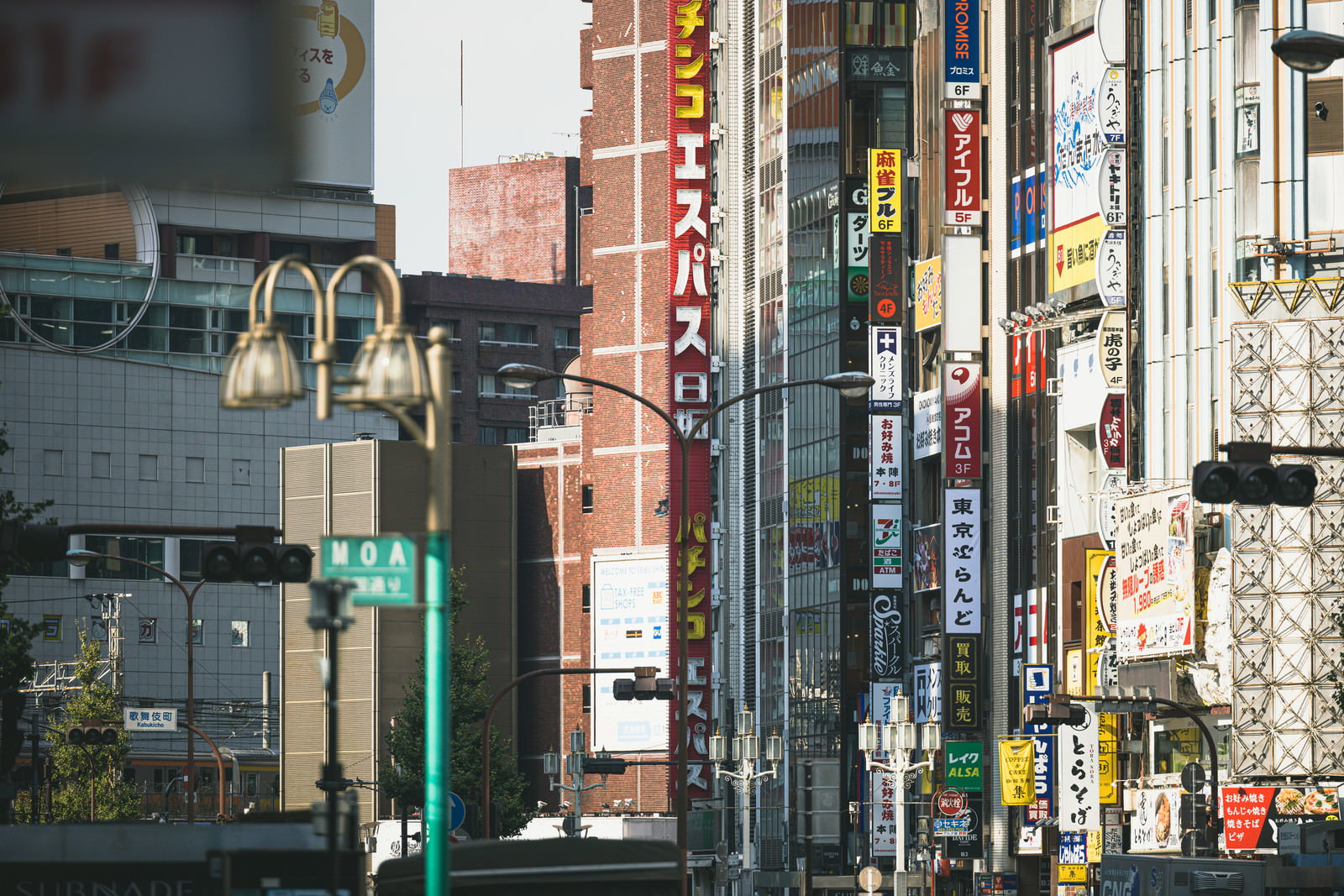 新宿の建物に多数の看板や袖看板が設置された都市景観