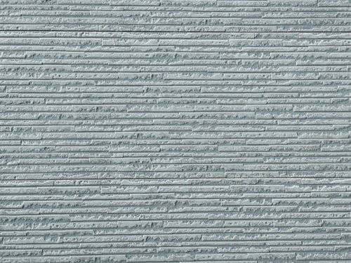 ダメージ加工されたグレーのタイル壁の外壁テクスチャー