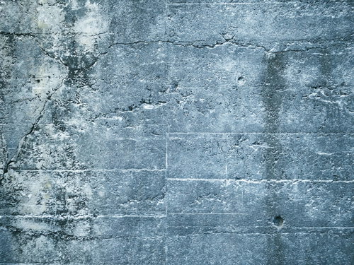 白い筋が残るグレーのコンクリート壁のテクスチャ