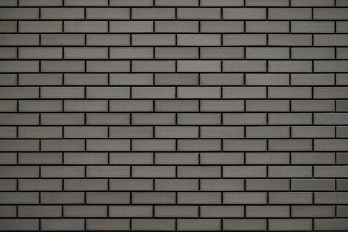 薄汚れたグレータイル壁のテクスチャー