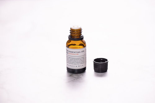 黒いキャップが外された茶色いエッセンシャルオイルの小瓶