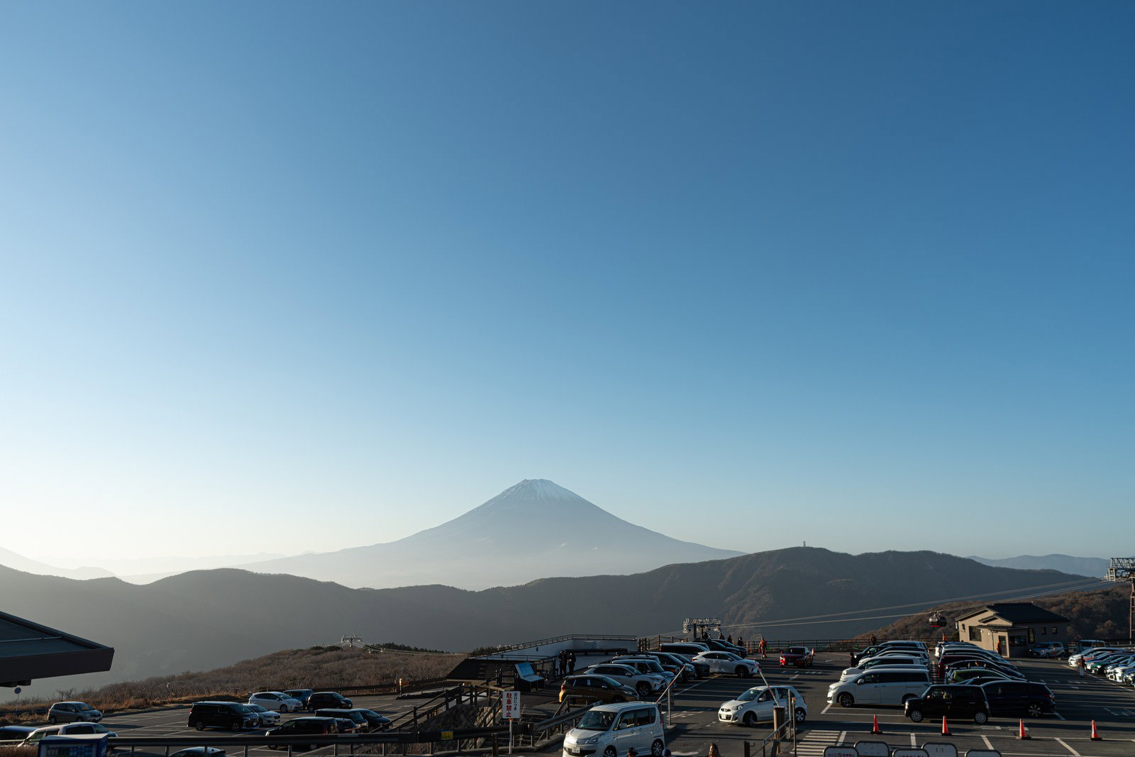 大涌谷の駐車場から見た富士山のシルエットが青空に映える風景