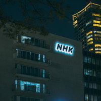 井の頭通りから見える夜間のNHK放送センタービルの写真