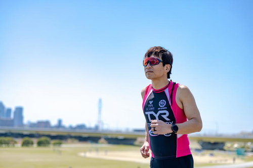 河川敷を走るトライアスロン選手の写真