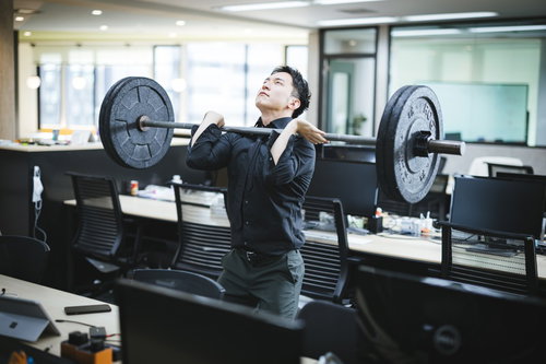 業績を上げる前にオフィスでバーベルを上げる経営者