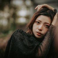 手すりにもたれ掛かる疲れた表情の女性ポートレートの写真