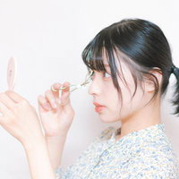ビューラーでまつ毛をカールさせるアイメイクテクニックの写真
