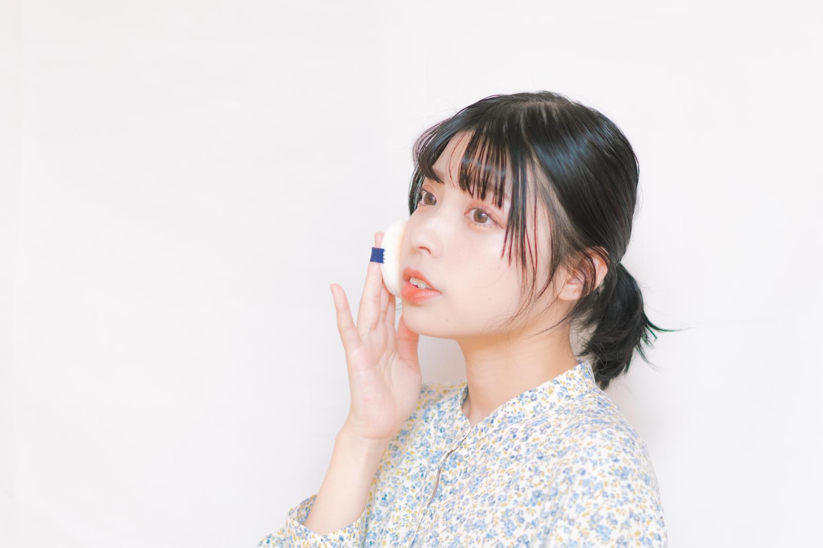リップパフを使って唇にリップコスメを塗布する女性［モデル：高尾実生］