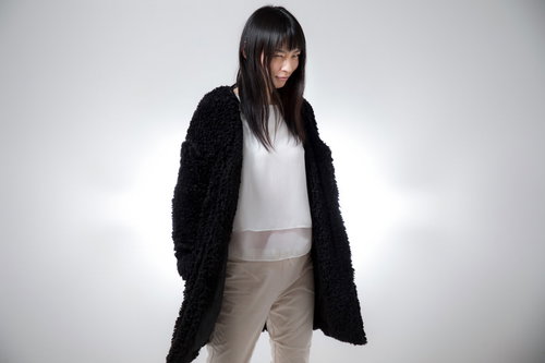 ほくそ笑みながらこちらを見つめる長髪の女性