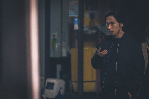 仲間と連絡を取り合い尾行する探偵の男性の捜査活動