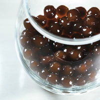 透明なグラスに入ったブラックタピオカドリンクの写真