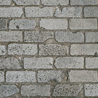 角の欠けたグレーのレンガ調タイルの床の質感テクスチャーの写真