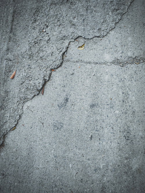 雑に舗装された地面のコンクリートテクスチャー