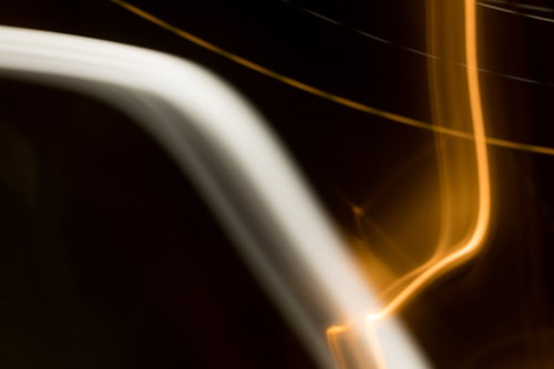 暗闇の中を通り過ぎるオレンジ色の光跡