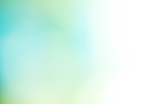 淡い緑の光が柔らかくグラデーションする自然のボケ背景