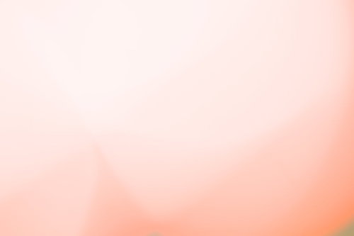 淡いピンクからオレンジ色へ変化するグラデーション背景