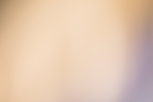 色あせた暖色系の光のボケ背景