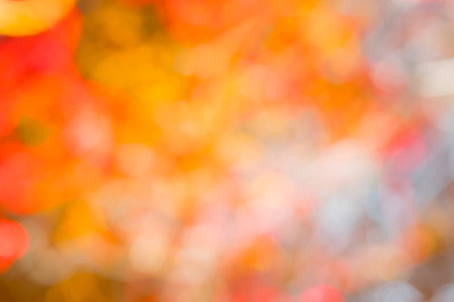 蠢くオレンジの光と円形ボケ、暖色グラデーション背景