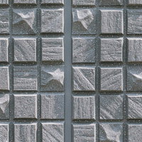 グレーの正方形いびつなタイルの外壁テクスチャーの写真