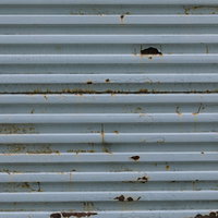 錆びた凹凸のあるシャッターのテクスチャーの写真