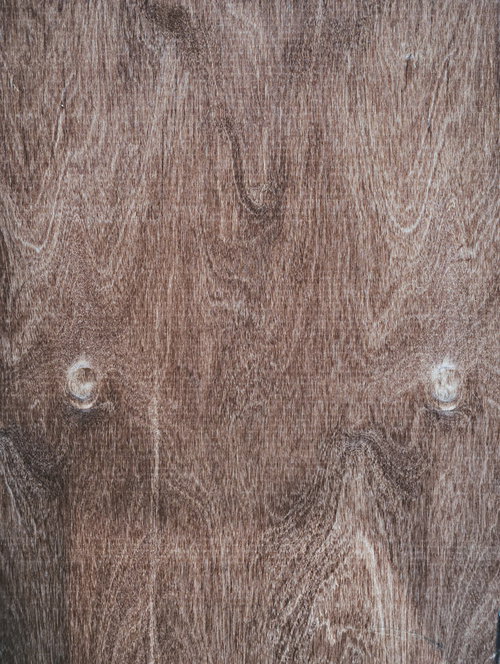 シミのように浮かび上がる木目と節が点在する木板のテクスチャ