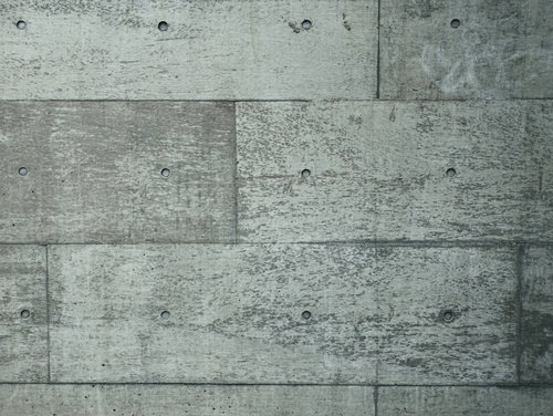 コンクリート打ちっぱなしの壁に残るピーコン跡と無機質なテクスチャー