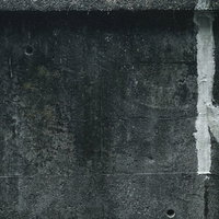 グレーのコンクリート壁の補修跡（テクスチャ）の写真