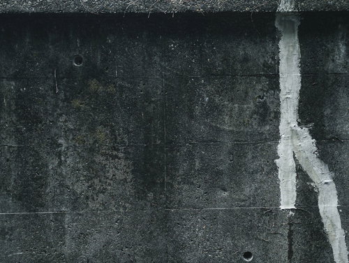 グレーのコンクリート壁の補修跡（テクスチャ）