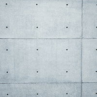 塞いだピーコン穴とコンクリート打ちっぱなしの壁面テクスチャの写真