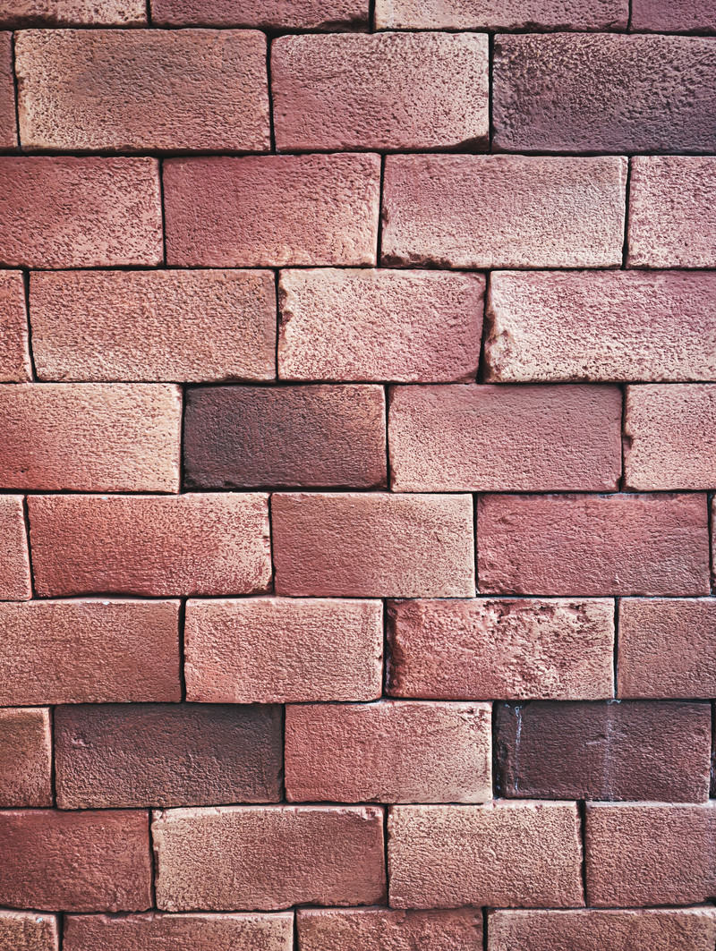 赤茶色のレンガが規則的に積まれた壁のテクスチャー