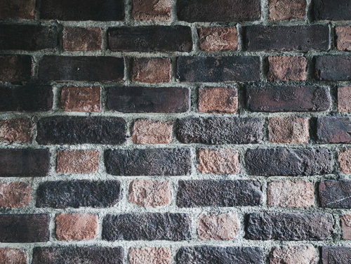 赤茶色と濃い茶色の二色レンガ壁のテクスチャー