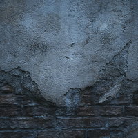 煉瓦の外壁を覆うコンクリート補修（テクスチャ）の写真