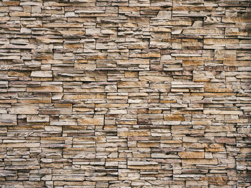 茶色の石材タイルを積み上げた壁のテクスチャ