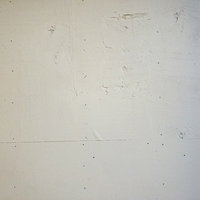 白く塗られたベニヤ板の壁面テクスチャの写真