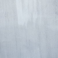 白く塗装された外壁のテクスチャーと陰影の写真