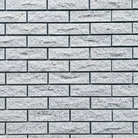 溝の深いグレー系石材タイルの外壁テクスチャーの写真