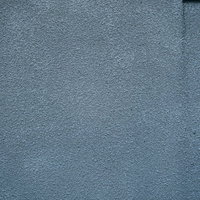 雨ダレが流れるグレーのモルタル外壁テクスチャの写真